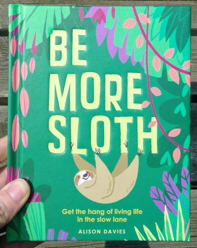 Green book cover featuring large block text and illustrations of a sloth hanging on vines.