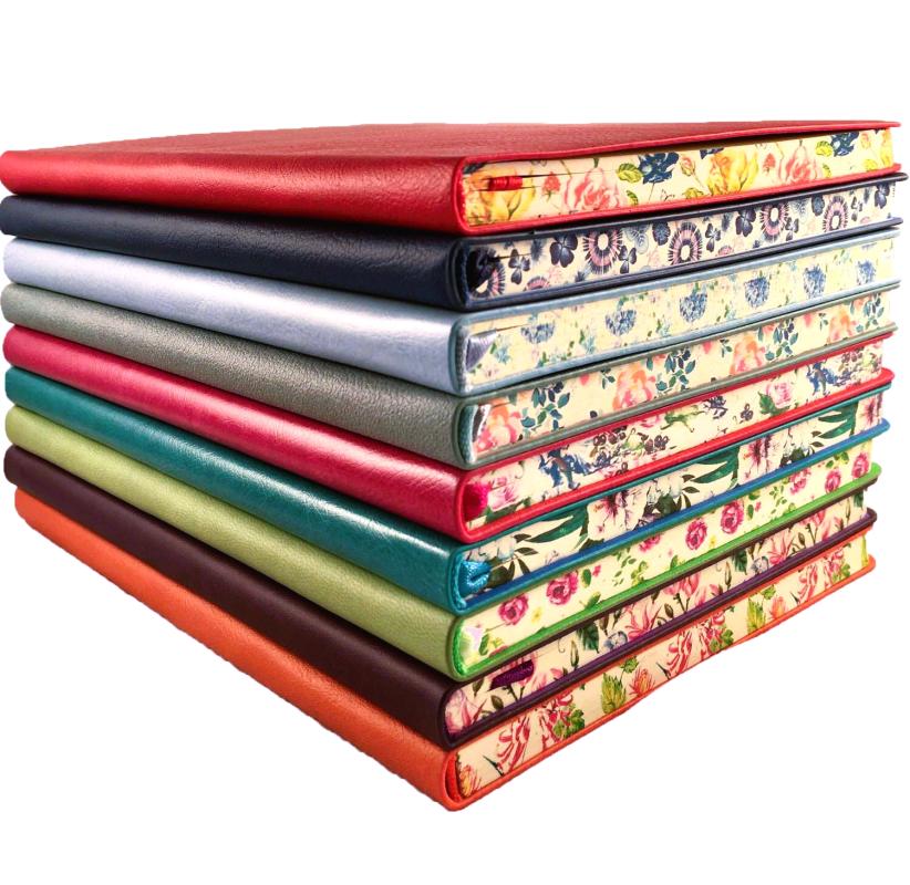 a stack of blank journals with floral trims