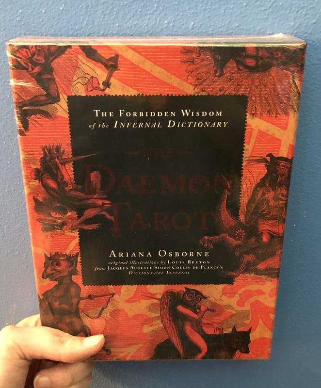 Illustrations of demonic creatures cover the background in red and black, with a black rectangle in the center of the cover. 