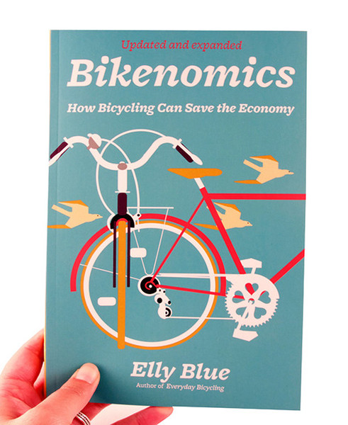 Blue book cover with two bicycles perpendicular to one another, birds fly behind them
