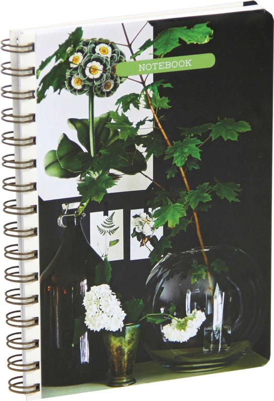 A spiral bound notebook with some pretty plants on it.