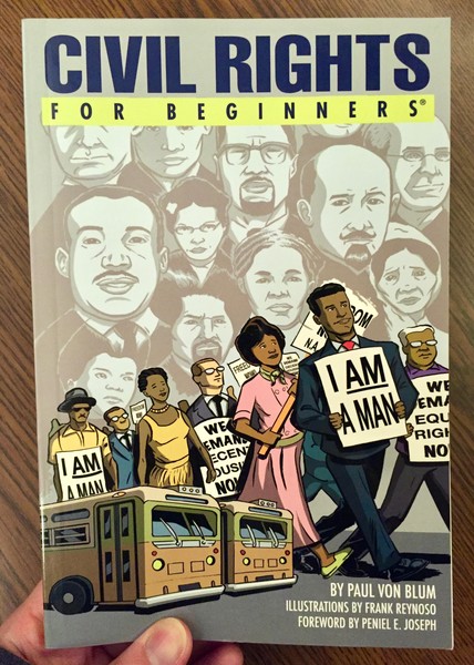 book cover depicting African Americans walking in a line with signs on a background of faces