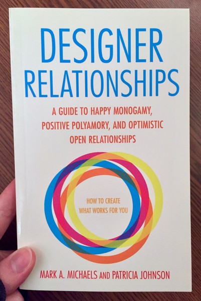 the cover of Designer Relationships: A Guide to Happy Monogamy, Positive Polyamory, and Optimistic Open Relationships, which has a series of interlocking rainbow colored circles prominently featured