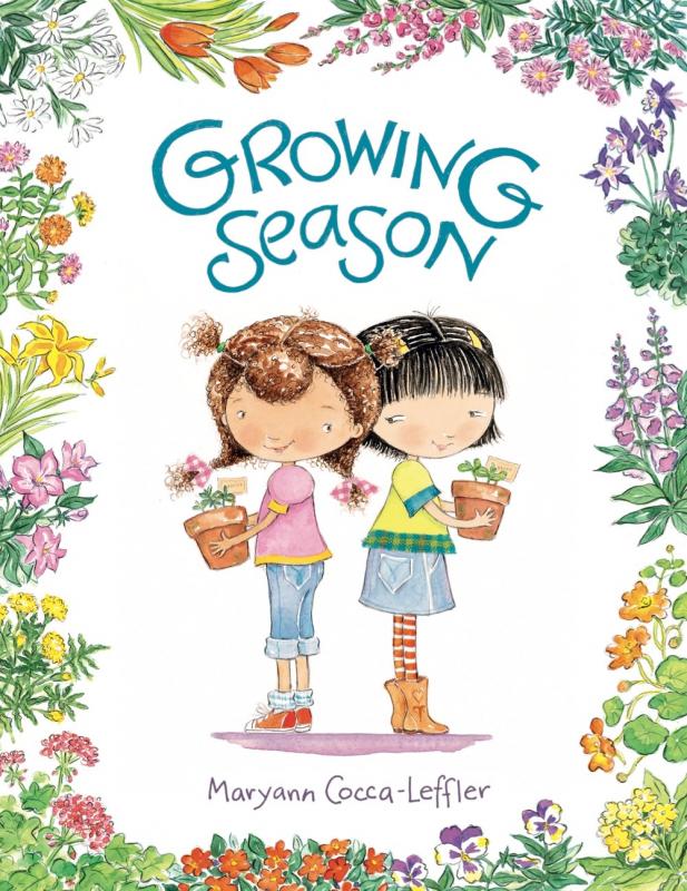 two illustrated girls stand back to back holding flower pots and the edge of the cover is ringed round with illustrated flowers