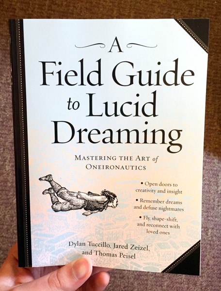 Cover of a field guide to lucid dreaming which features a ink drawing of a person flying through the air