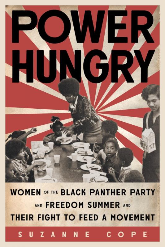 two black women distribute food to a table of black schoolchildren