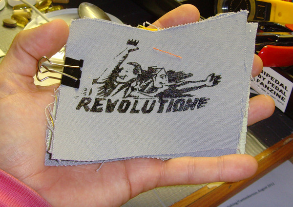 patch with people cheering that says "revolution"