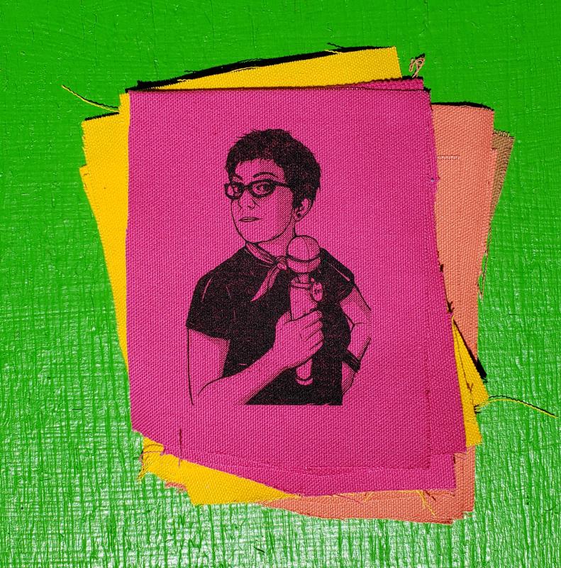 picture of a person holding a vibrator, screenprinted on a canvas patch