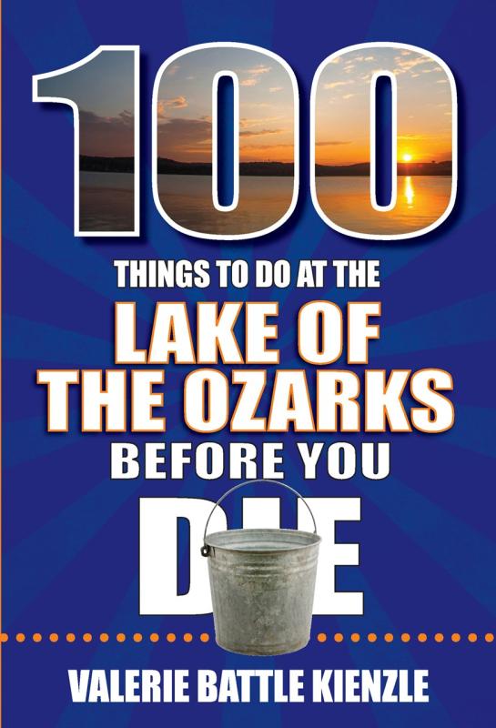 A 100 with a picture of a lakeside sunset with a bucket at the foot