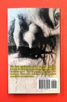 Back cover featuring close up sideways painting of an intimidating human face, with yellow descriptive text.