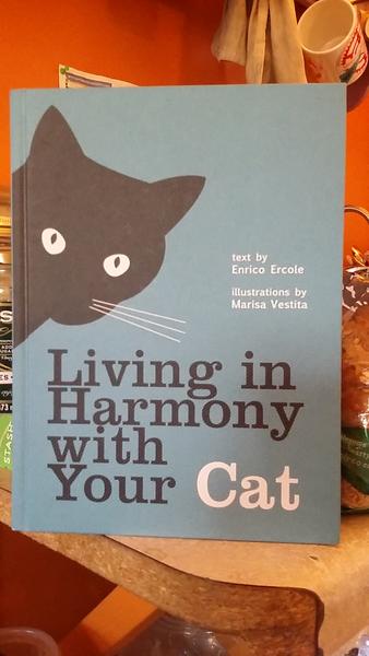 Living in Harmony with Your Cat by Enrico Ercole [An inquisitive black cat looms onto the cover.]