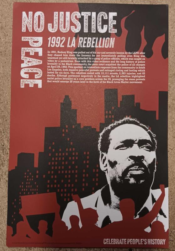 Rodney King, between a crowd and a city skyline appearing to be on fire