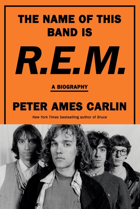 orange cover with bold black text and close up portrait of the band