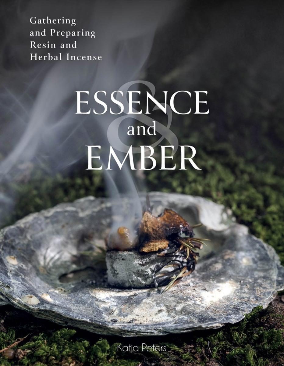 Smoking, burning matter in a stone dish atop a surface of dried substrate