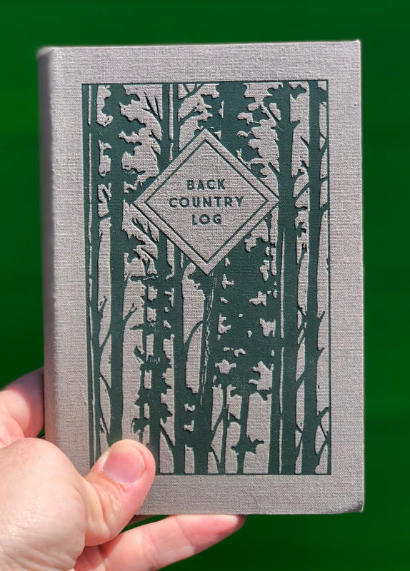 a cool grey cover with the silhouette of trees across the front