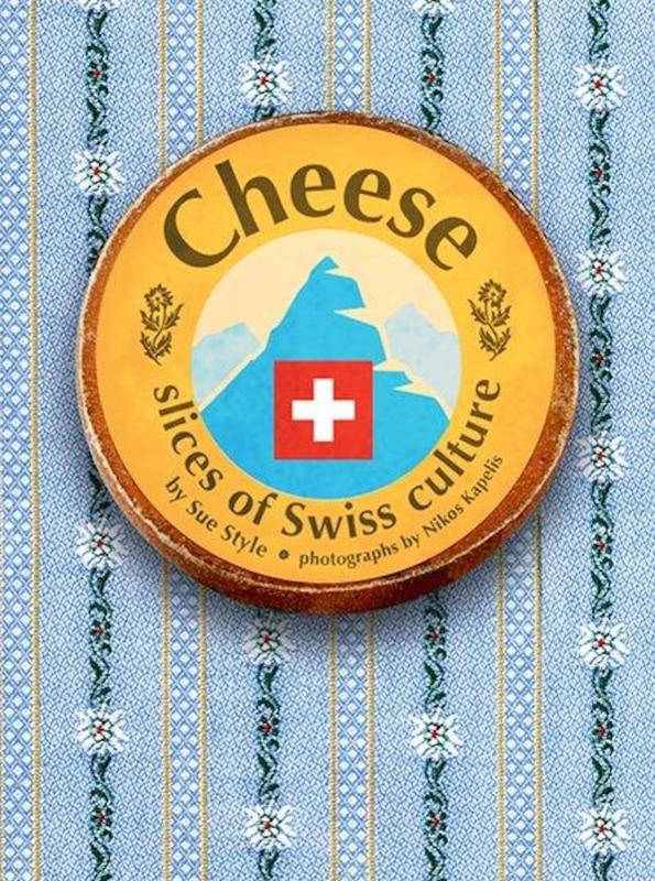 Book cover featuring the title displayed in a wheel of cheese on a blue patterned tablecloth.