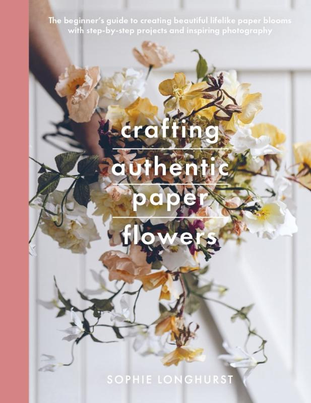 paper flowers on a stick over a white door
