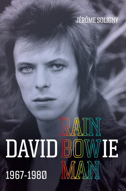 David Bowie looks into the camera, in greyscale photography