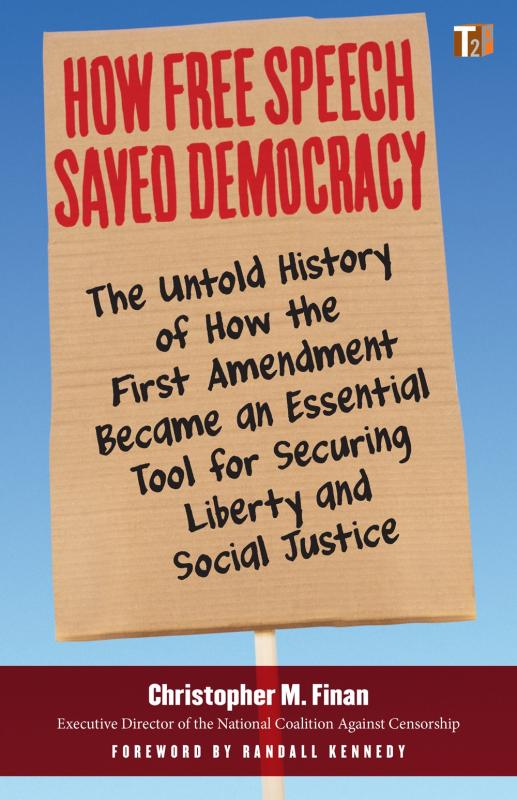 Cardboard protest sign, over a blue sky, containing the info text