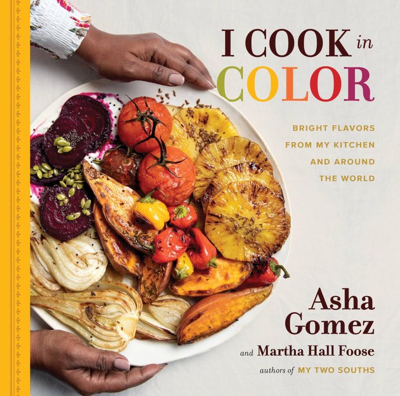Hands holding a plate with colorful roasted fruits and veggies