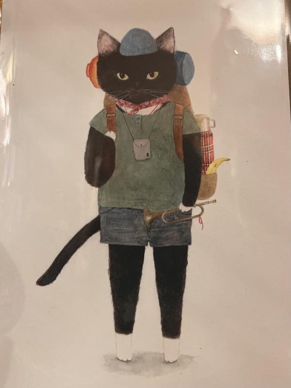 A black cat on two legs, with a backpack, ready for adventure