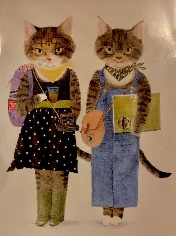 two humanoid cats, with a backpack, camera, coffee, and more 