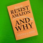 Zine. Bright orange cover with an illustration of a line and arrow tip arcing downward like a sad face