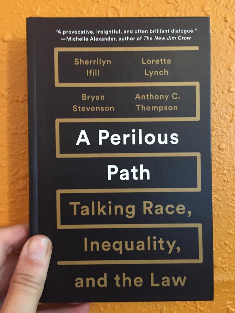 Black cover with a gold line boxing in the text