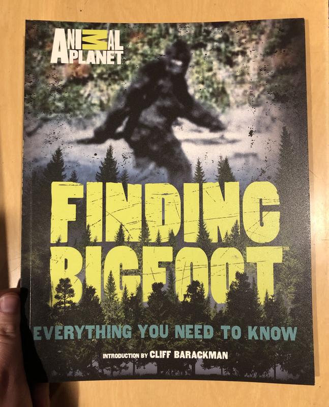 A blurry photo of Bigfoot and some trees decorating the title. 