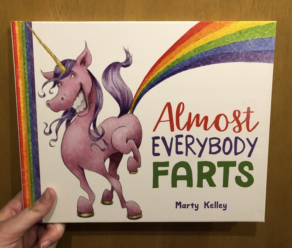 A pink and purple unicorn farting a rainbow. Hardcover. 