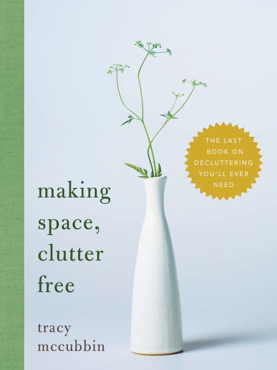 vase with a thin branchy plant, casting a small shadow on the light colored ground