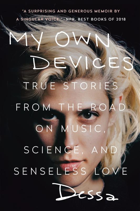 A close up photo of the author, a femme with dark eyes and blonde hair, staring intensely into the camera