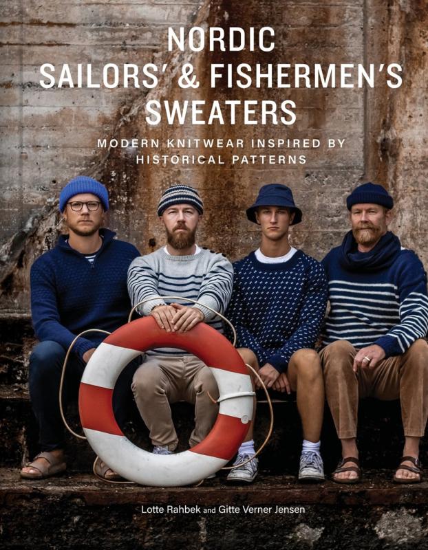 four sailors in sweaters next to a sea worn wall