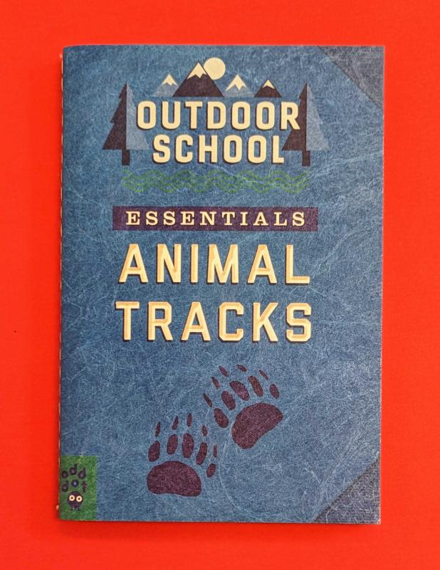 A blue cover with the silhouette of animal tracks.