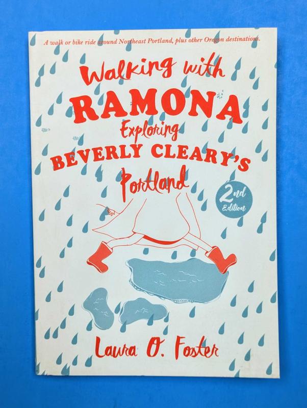 Ramona stepping over a puddle in the rain, in red rain boots