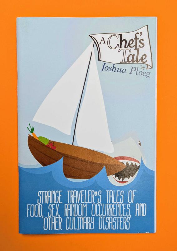 A zine with a shark taking a bite out of a small sailboat on the cover