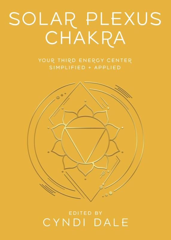yellow background with a gold symbol of a mandala like shape