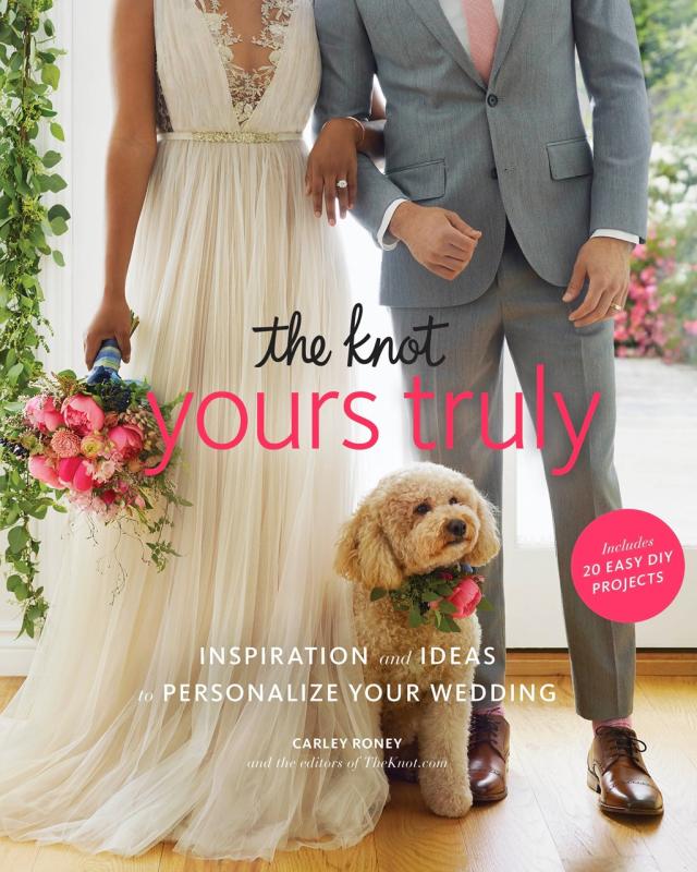 Body frame of a person in a suit and another in a dress holding a bouquet, with a poofy dog between them