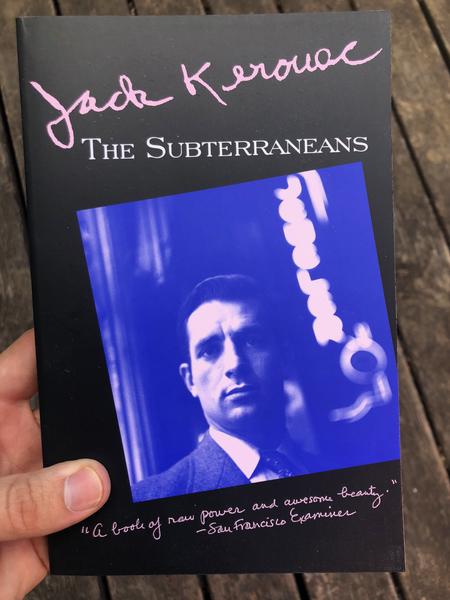 A blue tinted photo of Kerouac with a black border