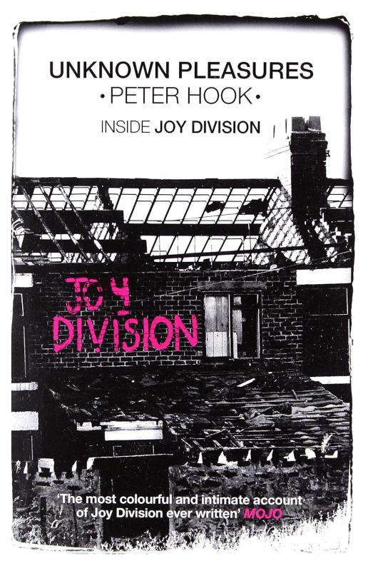 Photograph of a city building with pink paint reading Joy Division