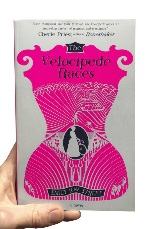 A white book with an illustration of a pink corset and a women in a dress with a bicycle