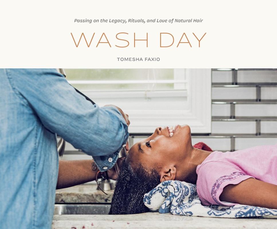 kid laying down next to the sink, ready to get their hair washed