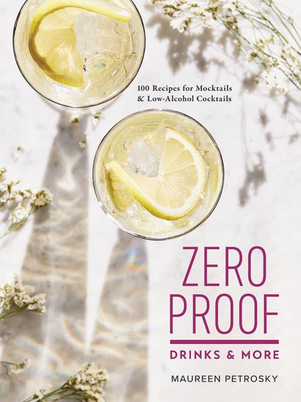 top down view of two glasses with lemon wedges over a white surface