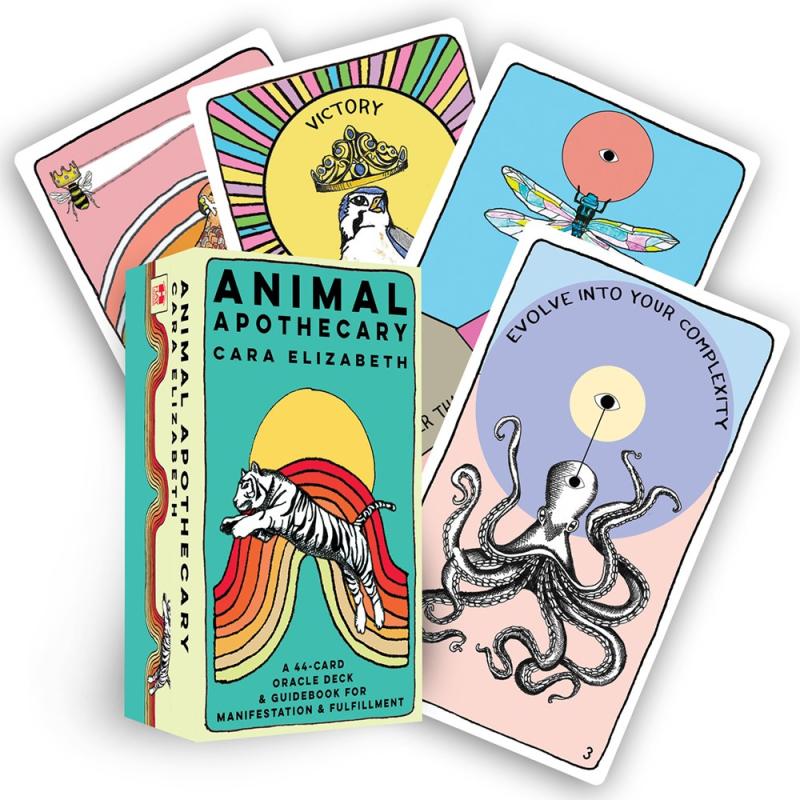 a box for a deck of oracle cards, with a white tiger jumping alongside a rainbow. various cards from the deck are pulled out