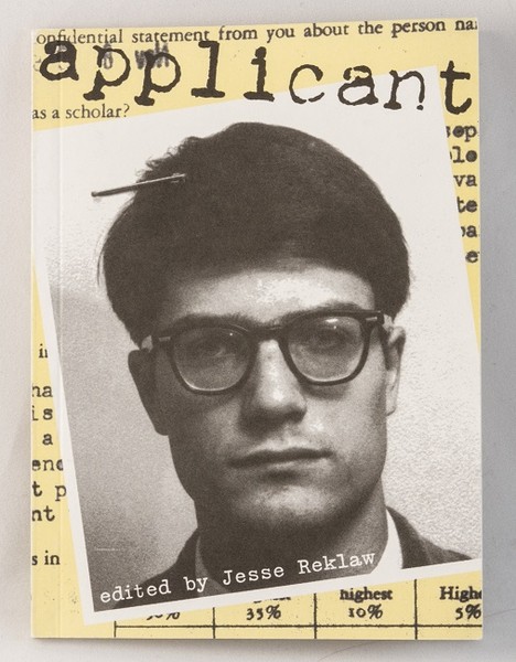 A yellow book with a photo of a young man with glasses