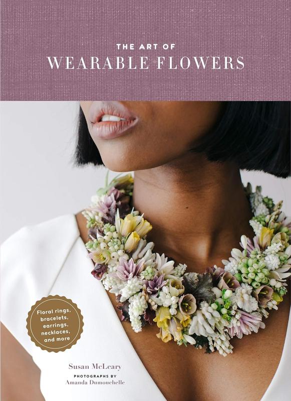close up of a persons neck with a necklace made of flowers