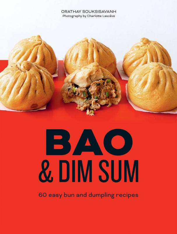 six dumplings on a red background, with one dumpling missing a bite