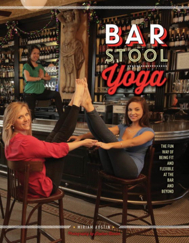 two people in workout clothes, in a bar, doing yoga