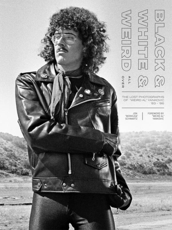 Weird-Al Yankovic striking a pose in a black leather jacket. 