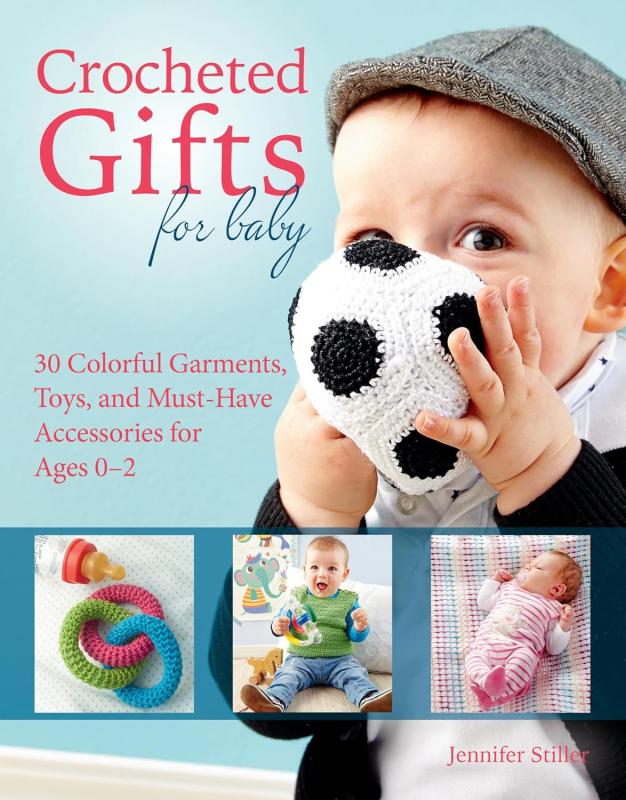 blue cover with close up of baby face holding a crocheted soccer ball